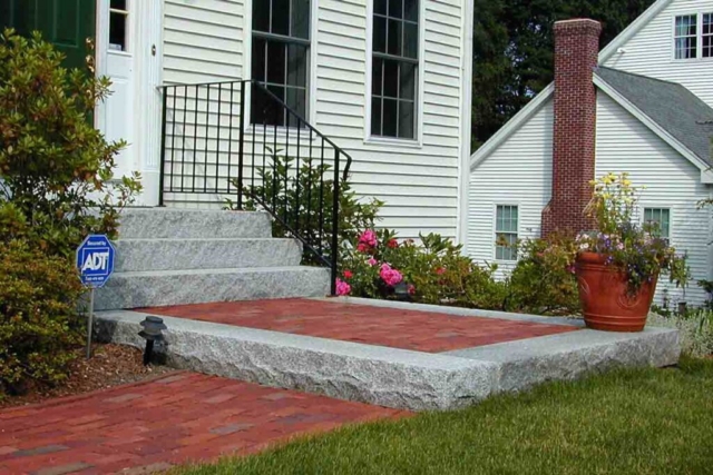 The Natural Landscape Inc. – Clay brick walkway with granite step and landings