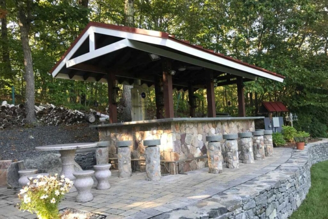 The Natural Landscape Inc. – Natural stone outdoor kitchen, bar and dining area