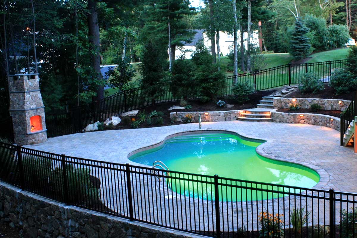 The Natural Landscape Inc. – New England fieldstone walls, steps and fireplace. Non-tumbled paver pool deck and coping.
