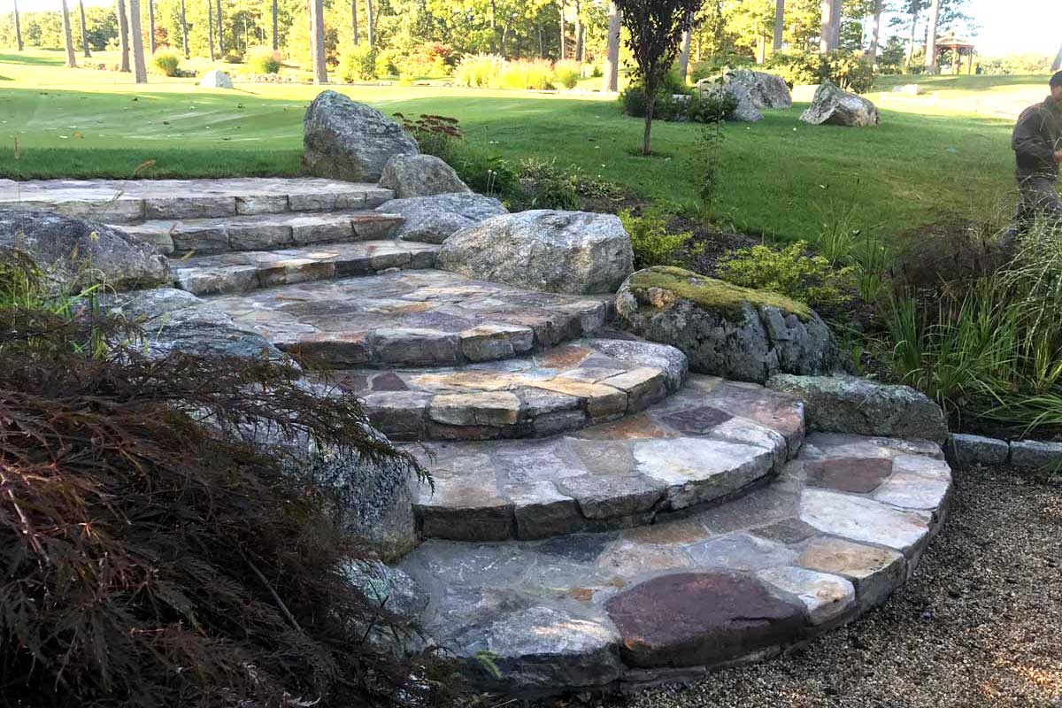 The Natural Landscape Inc. – New England fieldstone stairway with natural boulders